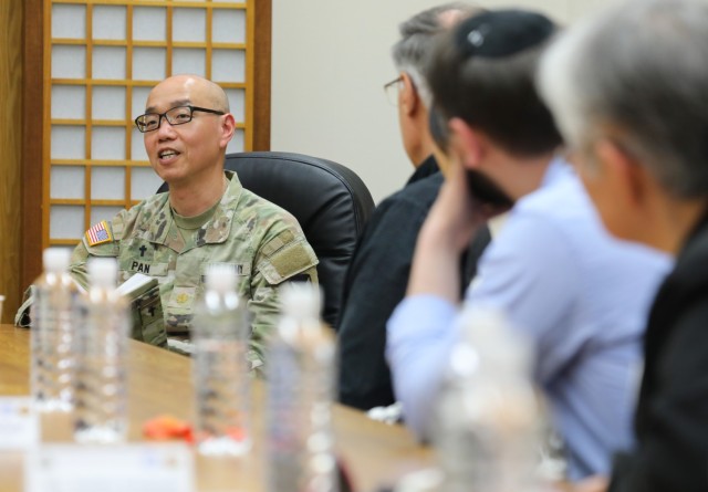 Maj. Tsung-Yu Pan, left, deputy command chaplain for U.S. Army Garrison Japan, introduces himself to members of the Tokyo Interfaith Council during their visit to Camp Zama, Japan, April 11, 2024. Council members and two Navy chaplains toured the installation while everyone exchanged information and ideas on how they can assist each other. 