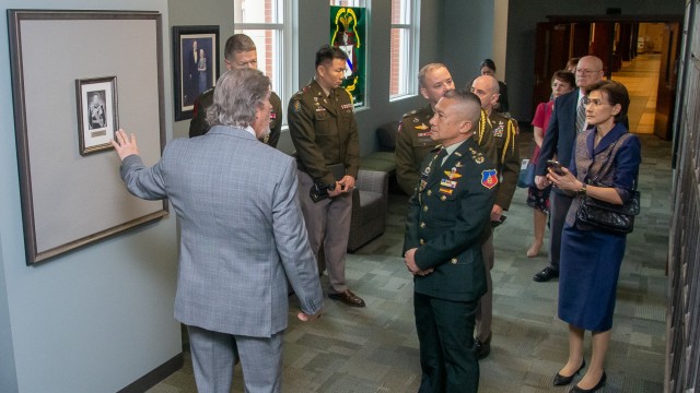 Gen. Songwit Noonpackdee, Chief of Defense Forces, Royal Thai Armed Forces, is shown his official photo by Jim Fain, Director, International Military Students Division, Command and General Staff College, that will be added to the CGSC's International Hall of Fame gallery following his induction ceremony April 2, 2024.