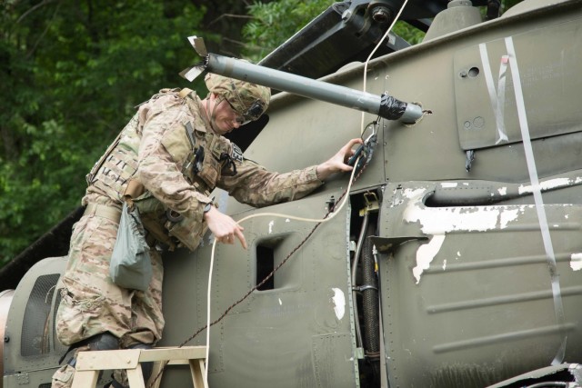Staff Sgt. Ryan Essenmacher, an explosive ordnance disposal team leader with the 720th Ordnance Company (EOD) from Baumholder, Germany, prepares a simulated explosive for removal on the Crash Site lane at Fort A.P. Hill, June 3, 2018. EOD teams are assessed on operations and associated tasks required to provide EOD support to unified land operations to eliminate and/or reduce explosive threats. The Ordnance Crucible is designed to test Soldiers’ teamwork and critical thinking skills as they apply technical solutions to real world problems improving readiness of the force. 