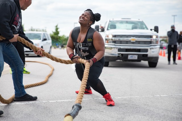 Two people hold a thick rope.
