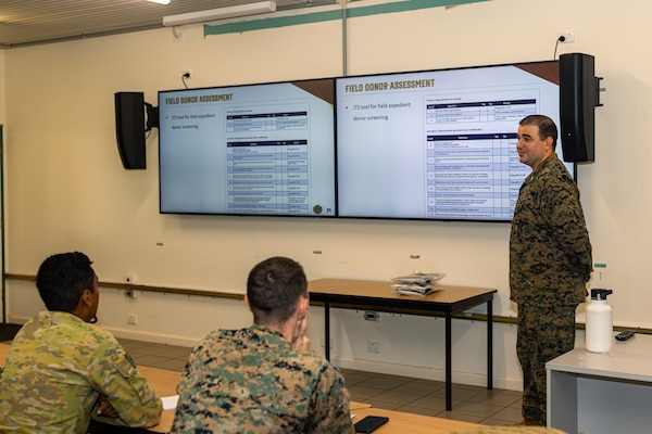 U.S. Navy Lt. Brett Marion, a lab officer with Combat Logistics Battalion 5 (Reinforced), Marine Rotational Force – Darwin 24.3, teaches U.S. Navy Corpsmen and Australian Army soldiers with 1st Health Battalion, 2nd Health Brigade, about blood transfusions during Valkyrie emergency fresh whole blood transfusion training at Robertson Barracks, Darwin, NT, Australia, May 15, 2024. The Valkyrie program enables military units to self-supply blood through emergency donor panels by adequate training, rehearsal, and preparation, gaining the skills and knowledge to efficiently collect whole blood, and conduct blood transfusions in the event of a casualty. Marion is a native of Maryland. (U.S. Marine Corps photo by Cpl. Juan Torres)