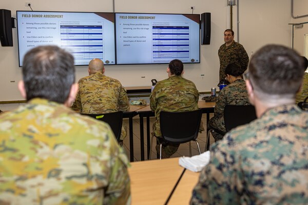 U.S. Navy Lt. Brett Marion, a lab officer with Combat Logistics Battalion 5 (Reinforced), Marine Rotational Force – Darwin 24.3, teaches U.S. Navy Corpsmen and Australian Army soldiers with 1st Health Battalion, 2nd Health Brigade, about blood transfusions during Valkyrie emergency fresh whole blood transfusion training at Robertson Barracks, Darwin, NT, Australia, May 15, 2024. The Valkyrie program enables military units to self-supply blood through emergency donor panels by adequate training, rehearsal, and preparation, gaining the skills and knowledge to efficiently collect whole blood, and conduct blood transfusions in the event of a casualty. Marion is a native of Maryland. (U.S. Marine Corps photo by Cpl. Juan Torres)
