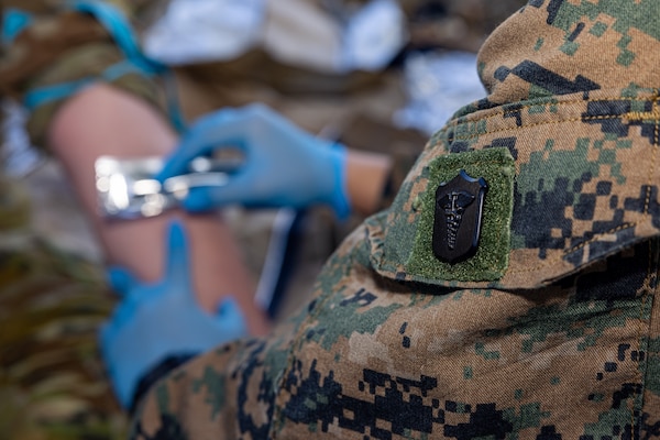 U.S. Navy Petty Officer 3rd Class Ariana Buckley, a hospital corpsman with Combat Logistics Battalion 5 (Reinforced), Marine Rotational Force – Darwin 24.3, prepares to draw blood during Valkyrie emergency fresh whole blood transfusion training at Robertson Barracks, Darwin, NT, Australia, May 16, 2024. The Valkyrie program enables military units to self-supply blood through emergency donor panels by adequate training, rehearsal, and preparation, gaining the skills and knowledge to efficiently collect whole blood, and conduct blood transfusions in the event of a casualty. Buckley is a native of New York. (U.S. Marine Corps photo by Cpl. Juan Torres)