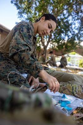 U.S. Navy Petty Officer 3rd Class Ariana Buckley, a hospital corpsman with Combat Logistics Battalion 5 (Reinforced), Marine Rotational Force – Darwin 24.3, prepares to draw blood during Valkyrie emergency fresh whole blood transfusion training at Robertson Barracks, Darwin, NT, Australia, May 16, 2024. The Valkyrie program enables military units to self-supply blood through emergency donor panels by adequate training, rehearsal, and preparation, gaining the skills and knowledge to efficiently collect whole blood, and conduct blood transfusions in the event of a casualty. Buckley is a native of New York. (U.S. Marine Corps photo by Cpl. Juan Torres)
