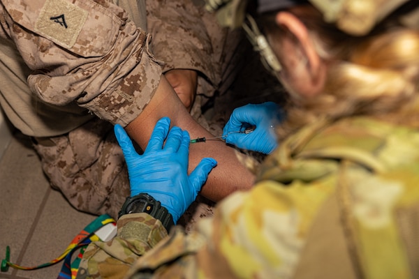 Australian Army PTE. Melissa Murray, right, a medical technician with 1st Health Battalion, 2nd Health Brigade, draws blood during Valkyrie emergency fresh whole blood transfusion training at Robertson Barracks, Darwin, NT, Australia, May 17, 2024. The Valkyrie program enables military units to self-supply blood through emergency donor panels by adequate training, rehearsal, and preparation, gaining the skills and knowledge to efficiently collect whole blood, and conduct blood transfusions in the event of a casualty. (U.S. Marine Corps photo by Cpl. Juan Torres)
