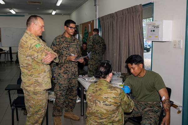 Australian Army Brigadier Douglas Pashley, the commander of 1st Brigade, observes U.S. Marines and Sailors with Marine Rotational Force – Darwin 24.3, and Australian Army Soldiers with 1st Health Battalion, 2nd Health Brigade, participating in Valkyrie emergency fresh whole blood transfusion training at Robertson Barracks, Darwin, NT, Australia, May 17, 2024. The Valkyrie program enables military units to self-supply blood through emergency donor panels by adequate training, rehearsal, and preparation, gaining the skills and knowledge to efficiently collect whole blood, and conduct blood transfusions in the event of a casualty. (U.S. Marine Corps photo by Cpl. Juan Torres)