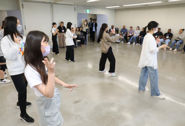 Japanese students perform a dance in front of Camp Zama volunteers during a language and cultural event at Zama City Hall, Japan, May 3, 2024. The volunteers helped a group of students get ready for an exchange trip this summer to Zama City’s sister city in Tennessee.