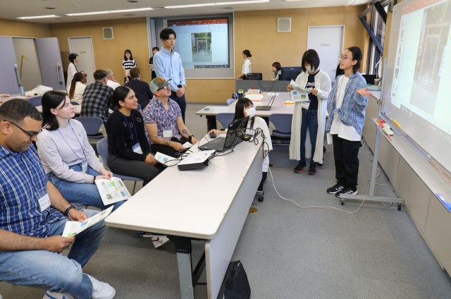 Momoko Yoshida, right, gives a presentation on Zama City to Camp Zama volunteers during a language and cultural event at Zama City Hall, Japan, May 3, 2024. The volunteers helped a group of students get ready for an exchange trip this summer to Zama City’s sister city in Tennessee.