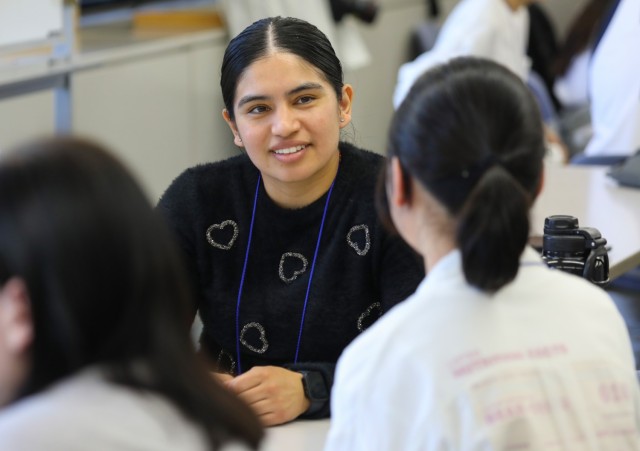 Sgt. Ashley Vasquez, assigned to U.S. Army Medical Department Activity-Japan, speaks with a Japanese student during a language and cultural event at Zama City Hall, Japan, May 3, 2024. The volunteers helped a group of students get ready for an exchange trip this summer to Zama City’s sister city in Tennessee.