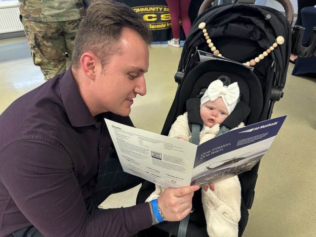Spc. Sean Ball shows his daughter, Sophia, that it is never too early to plan for your future. 