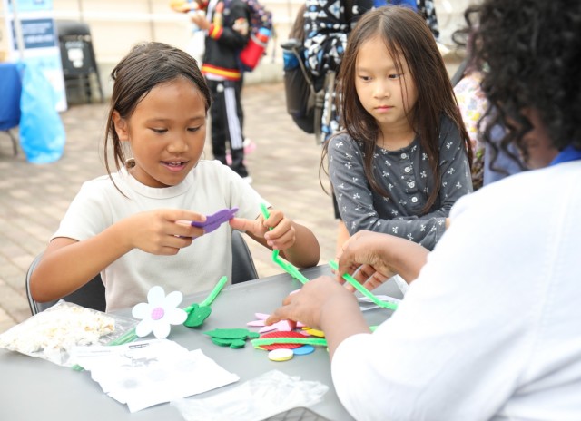 Shyane McIntyre, left, does arts and crafts during a pinwheel planting event in support of National Child Abuse Prevention Month at Sagamihara Family Housing Area, Japan, April 30, 2024.
