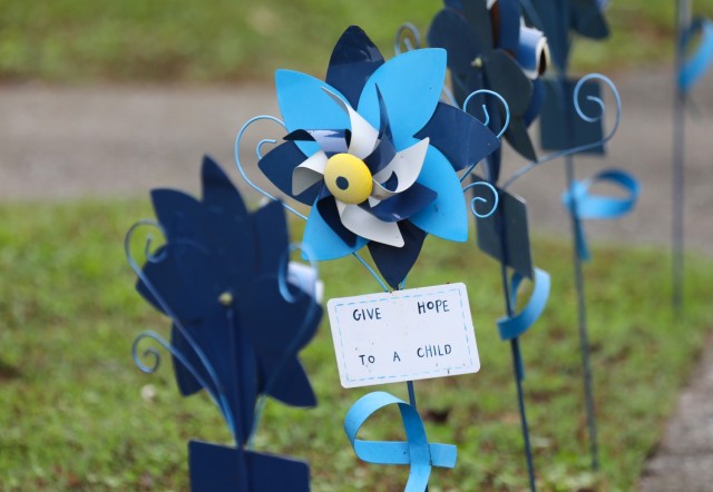 A pinwheel displays a message in front of the library at Sagamihara Family Housing Area, Japan, as part of a pinwheel planting event in support of National Child Abuse Prevention Month April 30, 2024.