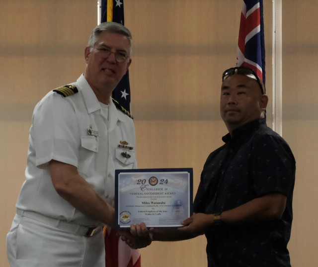 Miles Watanabe, Air Conditioning Equipment Mechanic Leader, U.S. Army Garrison Hawaii (right) accepts the Federal Employee of the Year – Trades and Crafts Excellence Award from Capt. Richard Jones, Commander, PHNSY & IMF at the Honolulu-Pacific Federal Executive Board’s Annual Excellence in Federal Government Awards ceremony at the Tradewinds facility on Joint Base Pearl Harbor Hickam, Hawaii on May 10.