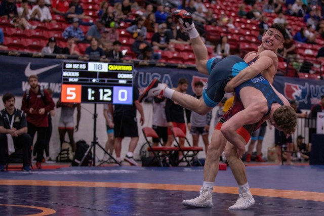 Spc. Spencer Woods lifts an opponent during a 2022 match.  Woods, who grew up in the Arctic Circle, Shungnak, Alaska, said his upbringing helped instill a strong work ethic. 