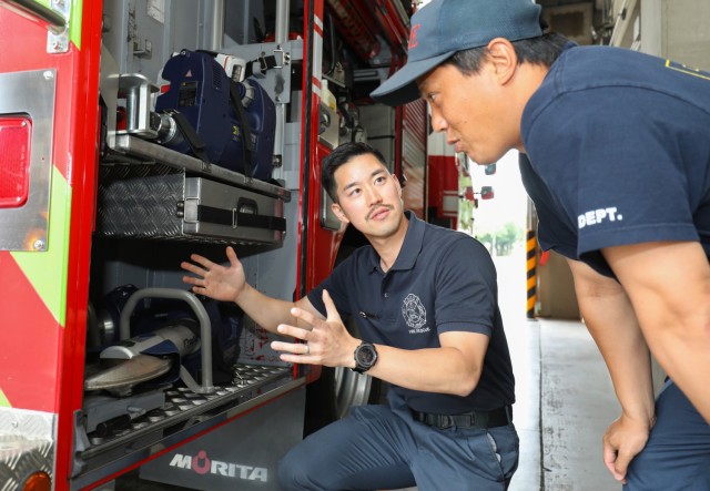 Capt. Koki Saito, center, a training captain for U.S. Army Garrison Japan's fire department, discusses the jaws of life equipment with Kengo Ishizuka, a firefighter, at Fire Station 1 on Camp Zama, Japan, May 16, 2024. Koki Saito and Yu Mori, a fire truck driver, traveled to Indianapolis to attend the Fire Department Instructors Conference in April where they received hands-on training on new procedures and best practices.