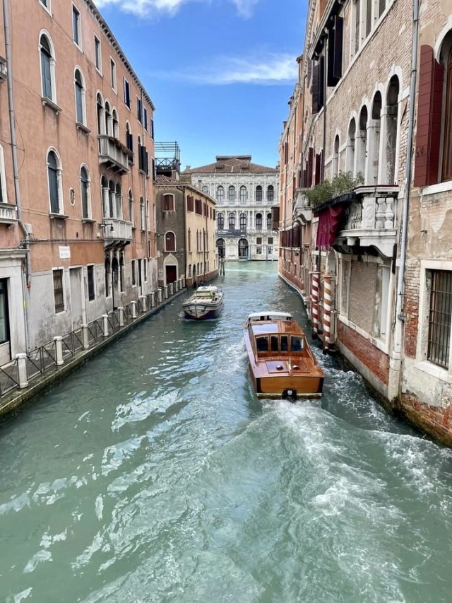 VICENZA, Italy - Speed boats cruise along the canals of Venice. Along with excessive tourism, climate change has created challenges for the city. Climatologists believe the beloved city could be entirely underwater within one hundred years. The Venice tourist tax of €5 per person through July 14, 2024, seeks to curtail this swell of crowds during Italy’s peak travel season.