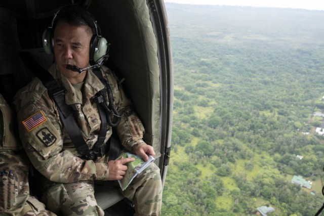 Brig. Gen. Kenneth Hara, Hawaii National Guard deputy adjutant general and Joint Task Force 5-0 commander, observes the ongoing volcanic activity aboard a UH-60 Blackhawk May 7, 2018, while in route to Leilani Estates, Pahoa, Hawaii. Hara is currently serving as a dual status commander, bearing the authority to call upon national guard and active duty resources to aid in the relief efforts. 