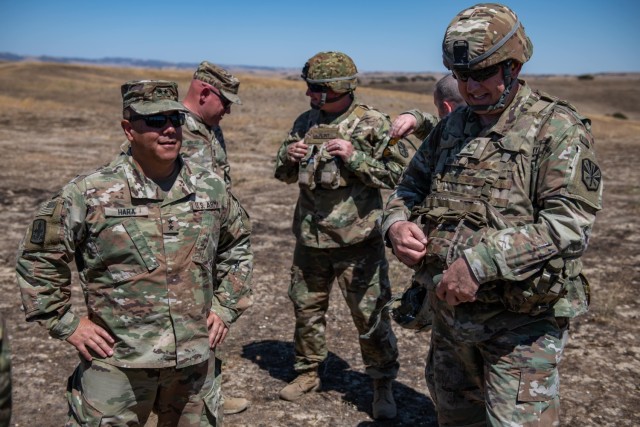 Maj. Gen. Kenneth S. Hara, The Adjutant General for the State of Hawaii, left, and Brig. Gen. Lonnie J. Branum, land component commander of the Arizona Army National Guard, observe a live-fire training exercise during the Exportable Combat Training Capability program on Camp Roberts, California, July 19, 2022. The TAG and staff visited with each TOC to assess multi-echelon performance and to ensure training is conducted safely and to standard.