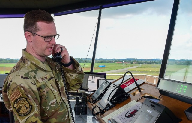 An air traffic controller for the 424th Air Base Squadron at Chièvres Air Base, makes radio contact with a pilot preparing to land an aircraft.