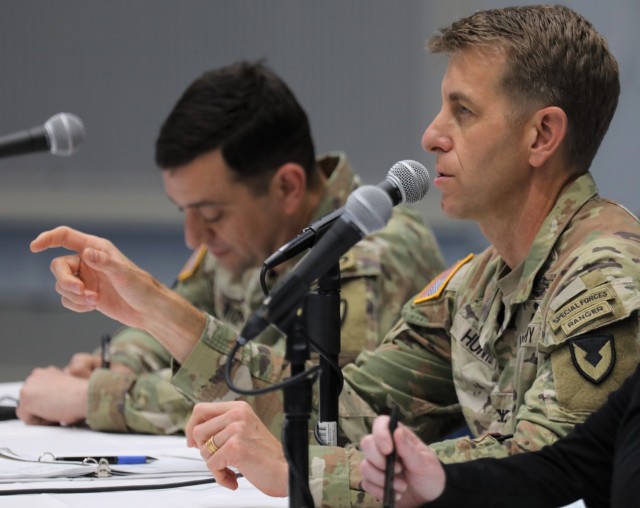 Col. Marcus Hunter, right, commander of U.S. Army Garrison Japan, speaks during a workforce town hall at Camp Zama, Japan, May 24, 2024. Command Sgt. Maj. David A. Rio, left, garrison senior enlisted leader, and Jenifer L. Peterson, deputy garrison commander, joined Hunter for the meeting at Kizuna Hall as they all answered questions from the audience.