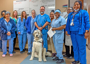 Clinic “staff member” lends a helping dog paw