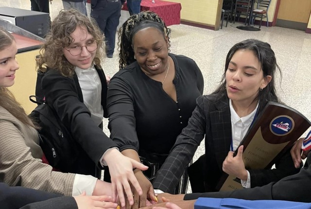 Allison Candelario, right, leads her school's forensics team during a competition in 2023. 