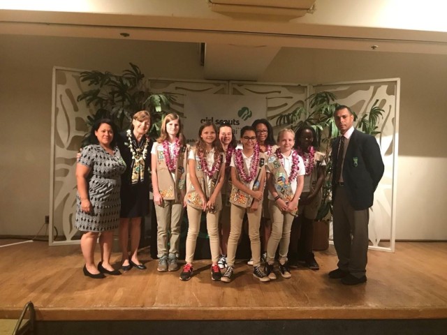 Allison Candelario, fourth from right, poses for a picture with her mom, Maria, far left, her father, Daniel, far right, and her girl scout troop in Oahu, Hawaii. 