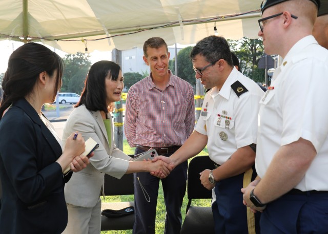 Col. Marcus Hunter, center, commander of U.S. Army Garrison Japan, and Zama City Mayor Mito Sato, left, meet with members of the U.S. Army Japan Band before their performance at an Independence Day celebration at Camp Zama, Japan, June 29, 2024....