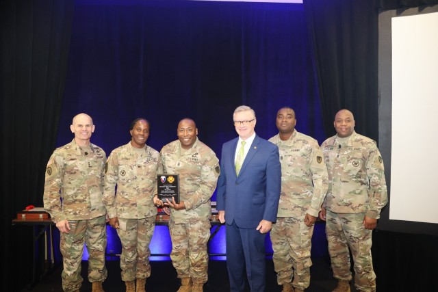 Six people pose for a photo.