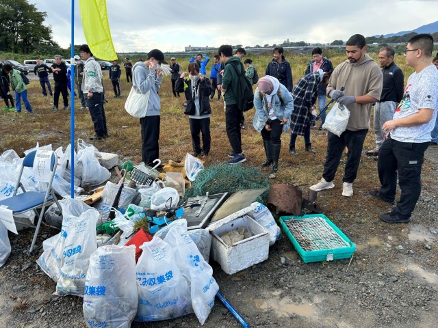 Members of Camp Zama's Better Opportunities for Single Soldiers program and other volunteers drop off bags of garbage they helped clean during a volunteer event Oct. 29, 2023, at the Sagamihara City Shindo Sports Park near Camp Zama. The BOSS...