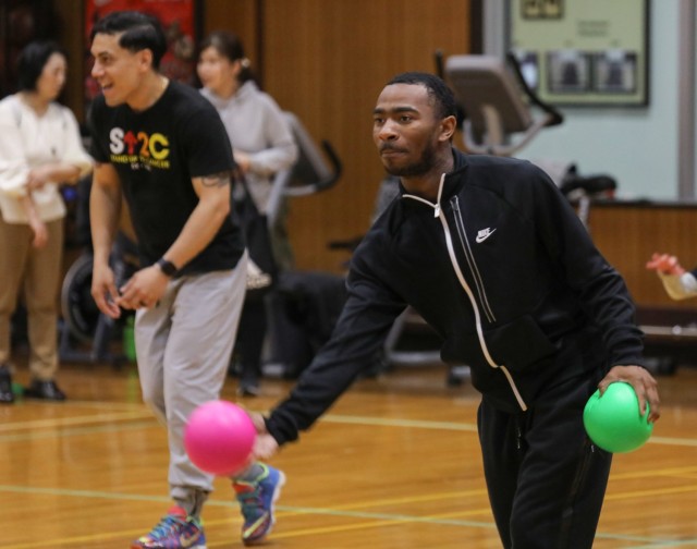 Sgt. Joshua McMath, right, a member of the Better Opportunities for Single Soldiers program, participates in a dodgeball game with children from the Sagamihara Minami Children’s Home during an outreach event at Camp Zama, Japan, April 3, 2024....