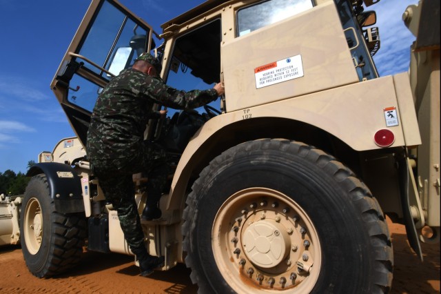 Lt. Col. Jorge Flechas, with the Colombian army’s engineer command, climbs onto a High Mobility Engineer Excavator while meeting with Soldiers of the 1223rd Engineer Company, South Carolina Army National Guard as they execute a construction...