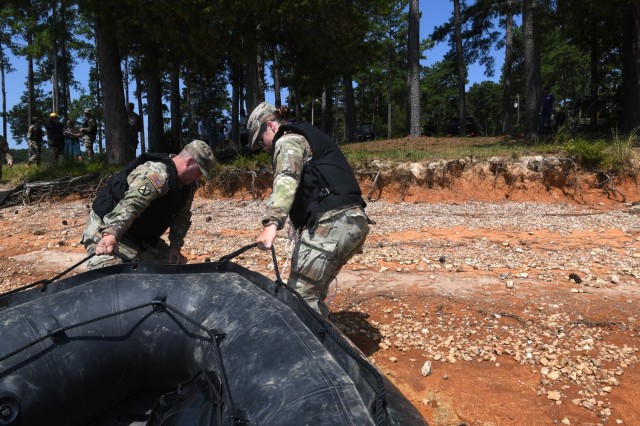 U.S. Army Sgt. Diego Franco, left, and U.S. Army Capt. Meredith Hohe, commander of the 125th Multi-role Bridge Company, South Carolina Army National Guard, pull a Combat Assault Craft small boat onto shore of the Savannah River during a training...