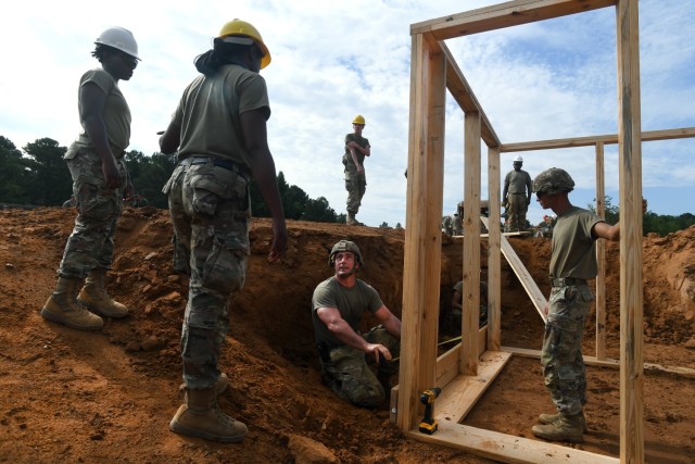 U.S. Army Staff Sgt. Russell Reagan, a construction supervisor with the 1223rd Engineer Company, South Carolina Army National Guard, goes over the next step in construction with members of his team while building fighting positions in a training...