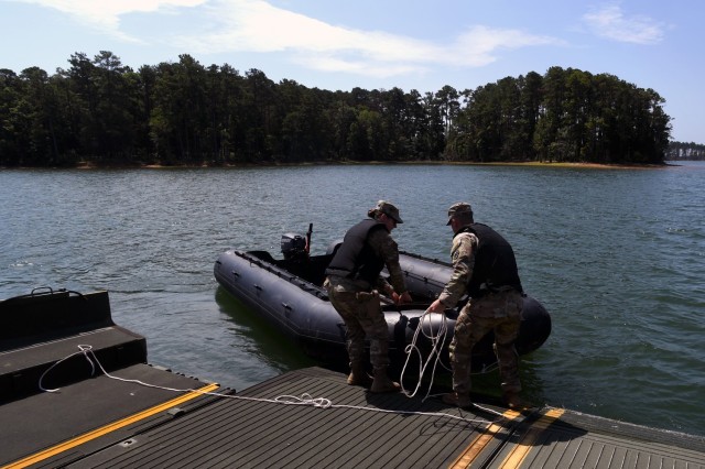 U.S. Army Capt. Meredith Hohe, commander of the 125th Multi-role Bridge Company, South Carolina Army National Guard, left, and U.S. Army 1st Lt. Clayton Calcagno, executive officer of the same unit, secure a Combat Assault Craft small boat to an...