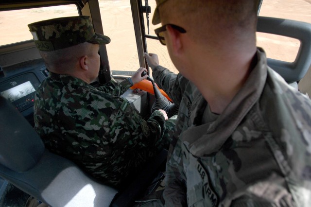 Lt. Col. Jorge Flechas, with the Colombian army’s engineer command, operates a High Mobility Engineer Excavator as U.S. Army Sgt. Zackery Tolson, a team leader with the 1223rd Engineer Company, South Carolina Army National Guard, provides...