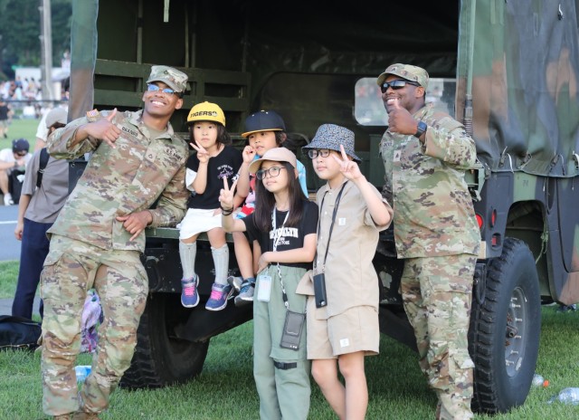 Children pose for a photo with 35th Combat Sustainment Support Battalion Soldiers during an Independence Day celebration at Camp Zama, Japan, June 29, 2024. The open-post event had plenty of food and entertainment including military static...