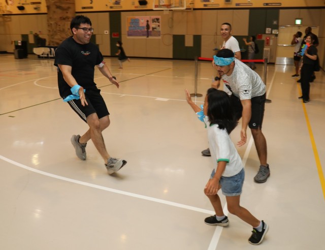 Camp Zama volunteers and residents of the Sagamihara Minami Children’s Home compete in a relay race during a mini-Olympics event at the Youth Center at Camp Zama, Japan, July 24, 2024. The event had six sporting activities and a medal ceremony...