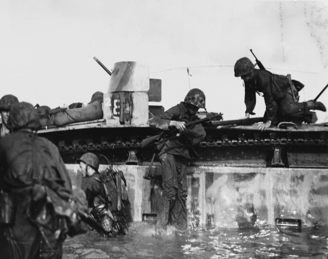 Soldiers and Marines use an LVT to transfer combat casualties to medical facilities on board Navy ships off Tinian, 26 July 1944.