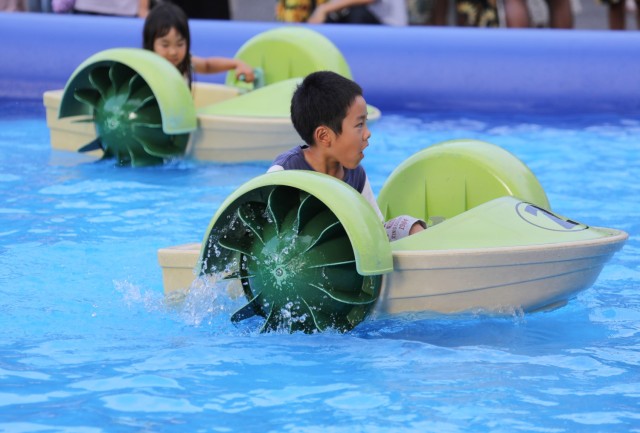 Children paddle toy boats during an Independence Day celebration at Camp Zama, Japan, June 29, 2024. More than 16,000 people attended the daylong event that had plenty of food and entertainment including children’s games, military static...