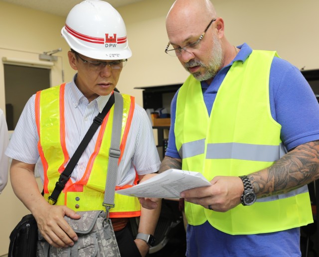 Satoru Itahashi, left, an electrical power dispatcher foreman, and Eli Craft, chief of operations and maintenance for U.S. Army Garrison Japan's Directorate of Public Works, participate in the "Black Start" exercise at Camp Zama,...