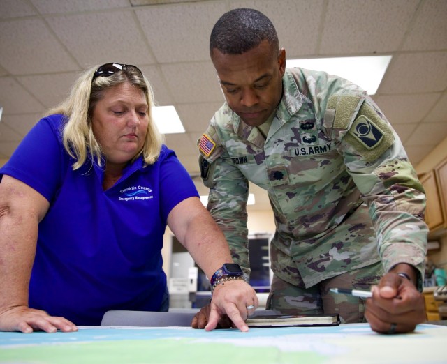 Florida Army National Guard 1st Squadron Commander, Lt. Col. Daniel S. Brown, with the 153rd Cavalry Regiment, discusses potential impacted areas of Hurricane Debby at the Franklin County Emergency Operations Center with Franklin County Director...
