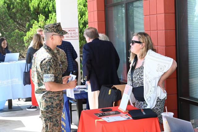 A Marine stationed at the Presidio of Monterey discusses educational opportunities with a representative from Indiana University of Technology at the Presidio of Monterey college fair at Aiso Library, Presidio of Monterey, Calif., July 25.
