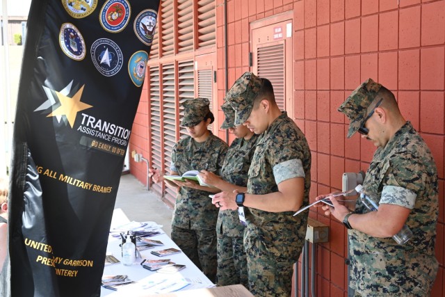 Four Marines take notes while a representative from the Presidio of Monterey’s Transition Assistance Program during the college fair at Aiso Library, Presidio of Monterey, Calif., July 25.