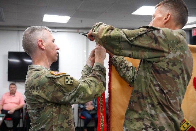 FORT MEADE, MARYLAND - Col. Michael A. Sapp, 88th Garrison Commander for Fort George G. Meade, adds the Army Superior Unit Award ribbon to the garrison colors.