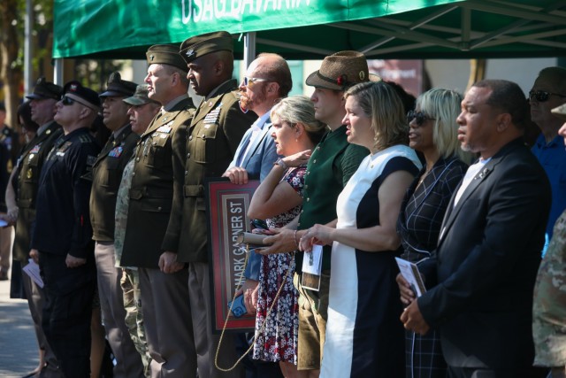 USAG BAVARIA - HOHENFELS, Germany -- A crowd of distinguished guests stands during the singing of the Army song. U.S. Army Garrison Bavaria dedicated a street to the memory of Capt. Mark A. Garner, a member of the Hohenfels community and former...