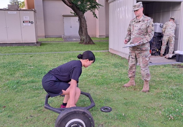 Japan Ground Self-Defense Force Sgt. Yumi Okazaki, left, executes a deadlift as part of the Army Physical Fitness Test while Sgt. 1st Class William Phillips observes. Williams was Okazaki’s sponsor during the most recent cycle of the...