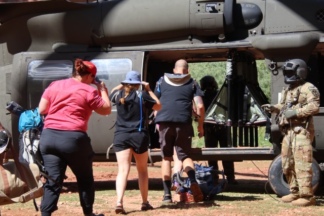 U.S. Army Soldiers of the Arizona National Guard (AZNG) guide tourists into a UH-60 Blackhawk, August 24, 2024 at the Havasupai Indian Reservation....