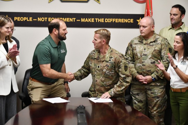 Garrison commander LTC Matthew Bauer shakes hands with DCR director Matthew Wells after signing the IGSA at Fort Walker on 1 August 2024