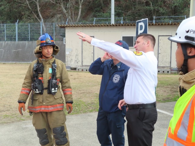Paul Buckner, center right, the Kure regional deputy fire chief, provides guidance during a joint training exercise with firefighters from U.S. Army Garrison Japan and the Kure Fire Department at Hiro Ammunition Depot, Japan, Feb. 13, 2024....
